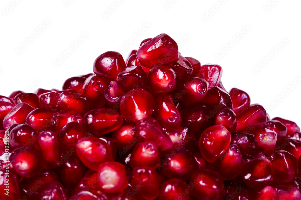 Pomegranate seeds pile with beautiful red fleshy seeds - isolated on white background Pomegranate seeds pile with beautiful red fleshy seeds - isolated on white background