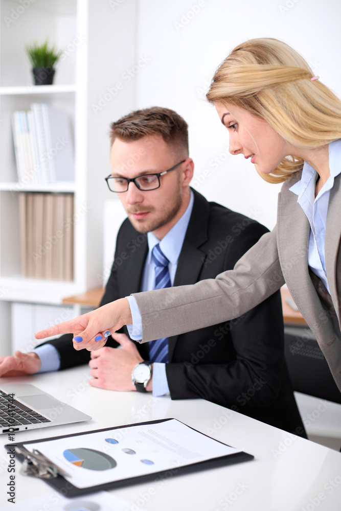 Two successful business partners working at meeting in office Two successful business partners working at meeting in office