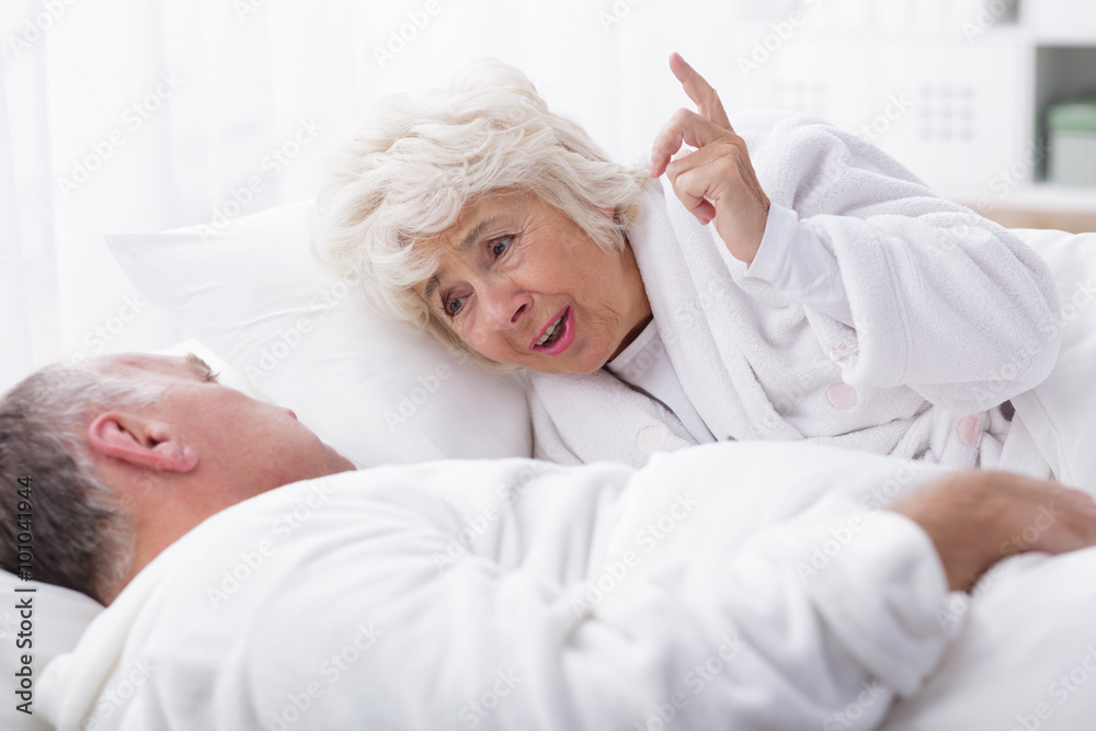 Senior marriage discussing in bed