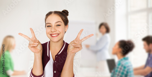 teenage student girl showing peace at school