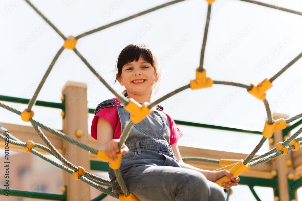 happy little girl climbing on children playground happy little girl climbing on children playground