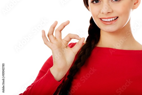 Young woman showing ok sign