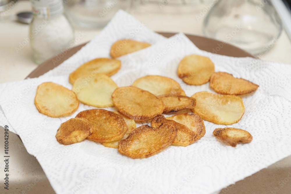 frying potato slices - preparing homemade chips