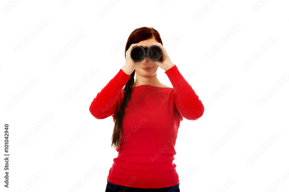 Young woman looking through a binocular Young woman looking through a binocular