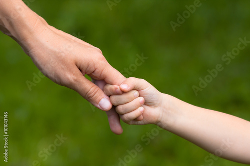 adult holding a hand of child © rodimovpavel