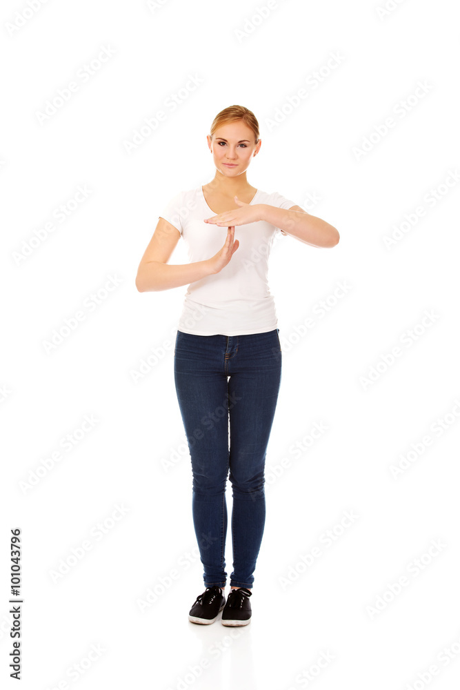 Young woman doing a break symbol Young woman doing a break symbol