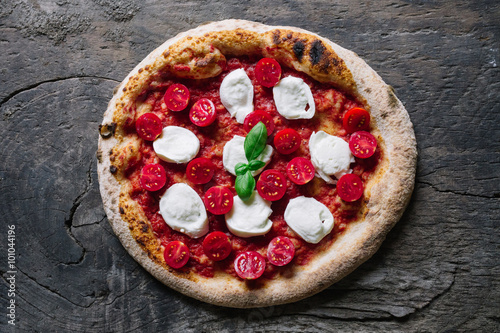 A Pizza Margharita with tomato sauce, mozzarella and basil