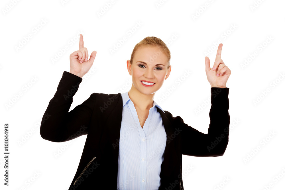 Young smiling business woman pointing up Young smiling business woman pointing up