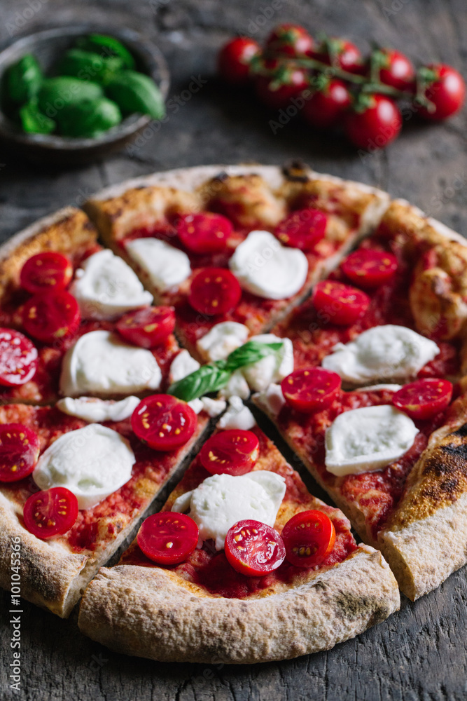 A Pizza Margharita with tomato sauce, mozzarella and basil A Pizza Margharita with tomato sauce, mozzarella and basil