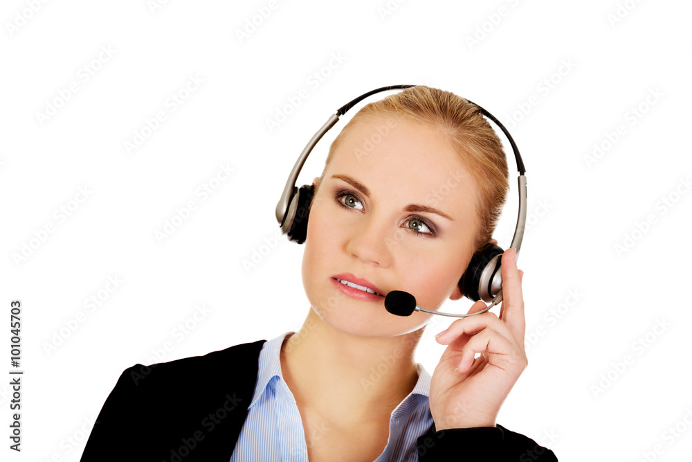 Young woman helpline operator is trying to hear something headphones Young woman helpline operator is trying to hear something headphones