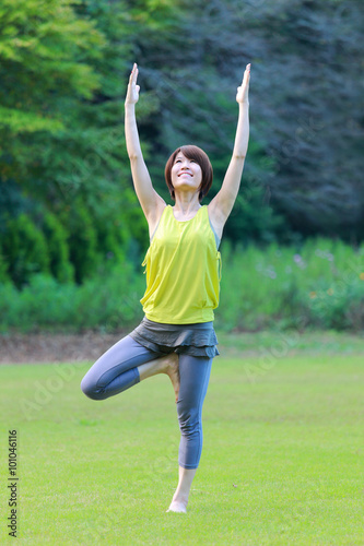 Japanese woman doing yoga tree pose