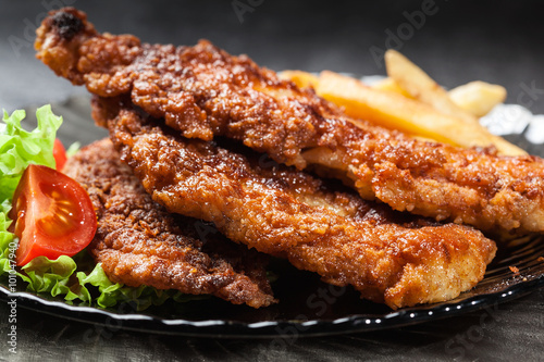 Fried fish in crispy batter with chips