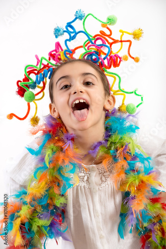 Happy little girl celebrating with party streamers