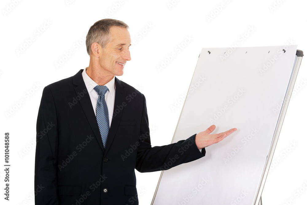 Male executive presenting on flip chart Male executive presenting on flip chart