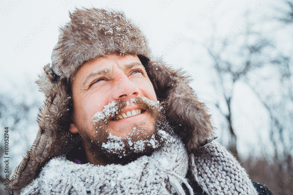 Fototapeta premium Portrait of a young handsome man with a beard. Bearded man in winter.