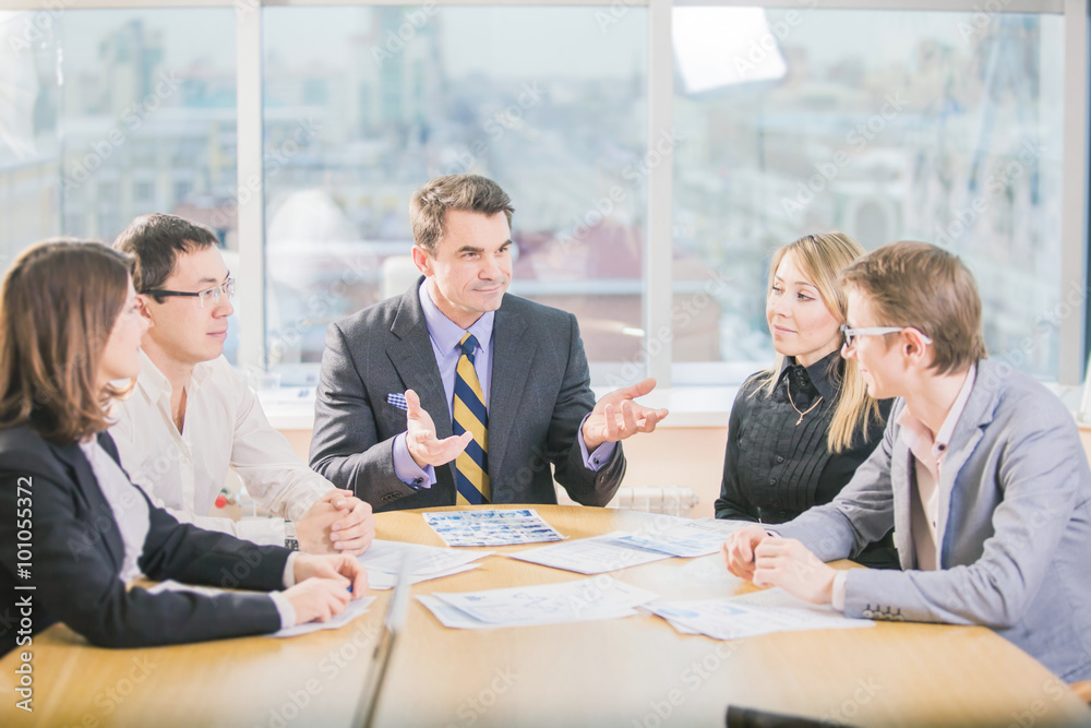 Five business people working together in the office Five business people working together in the office