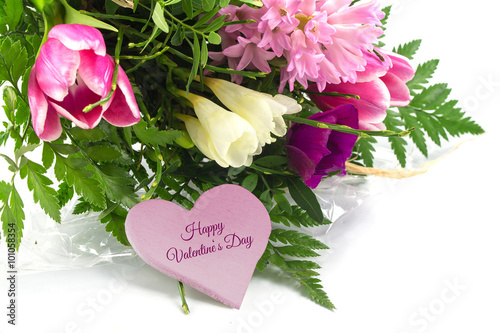 flower bunch and a pink heart shape  text happy valentine s day