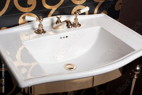 white bathroom sink on the decorated black wall