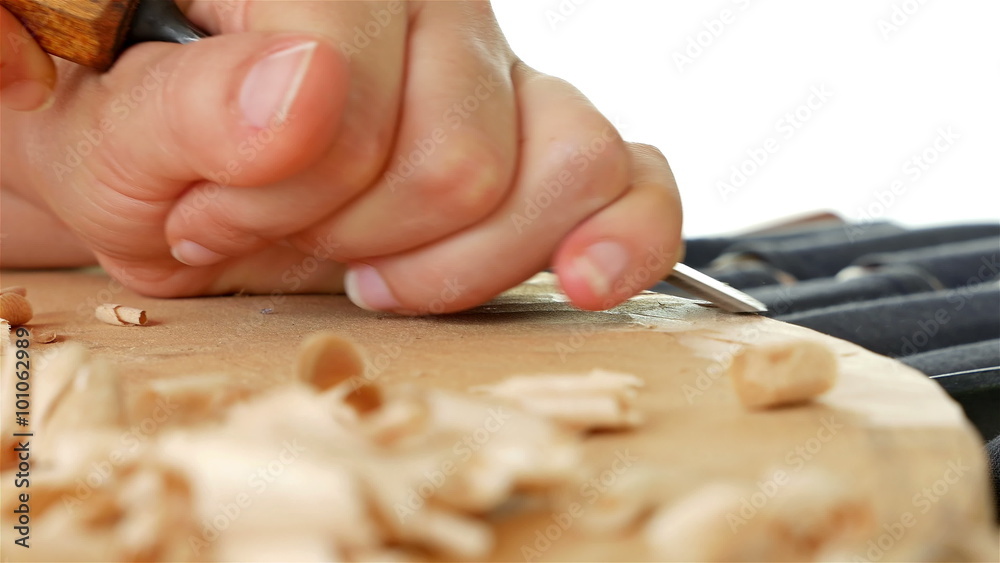 Wood carving - Human hand chiseling a piece of wood Wood carving - Human hand chiseling a piece of wood