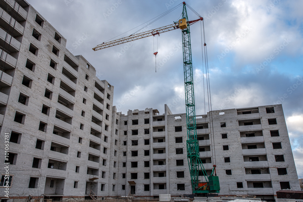 Crane construction bricks concrete building in city
