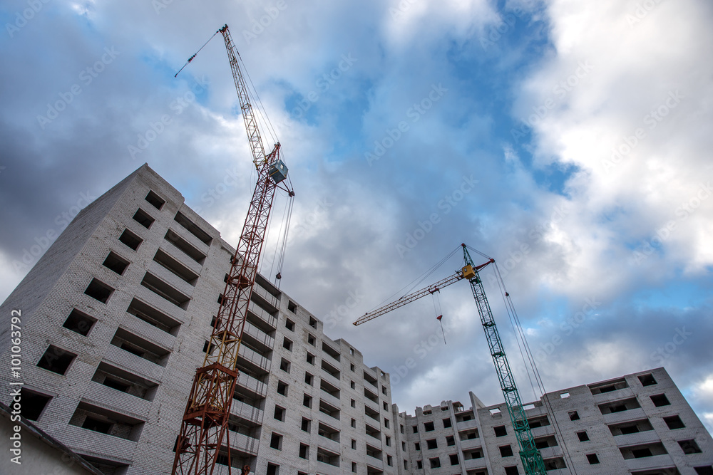 Crane construction bricks concrete building in city