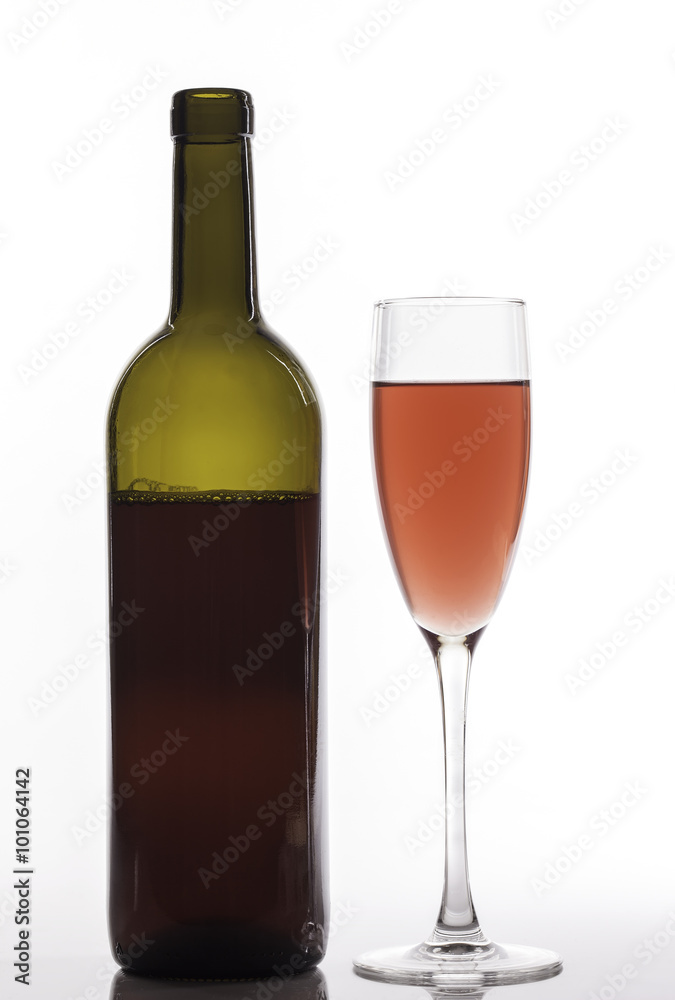 glass of pink wine and bottle on white background glass of pink wine and bottle on white background