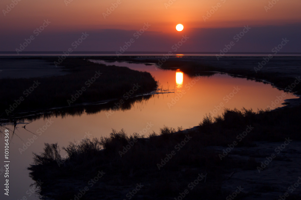 Beautiful nature landscape, sun reflected on water at sunset