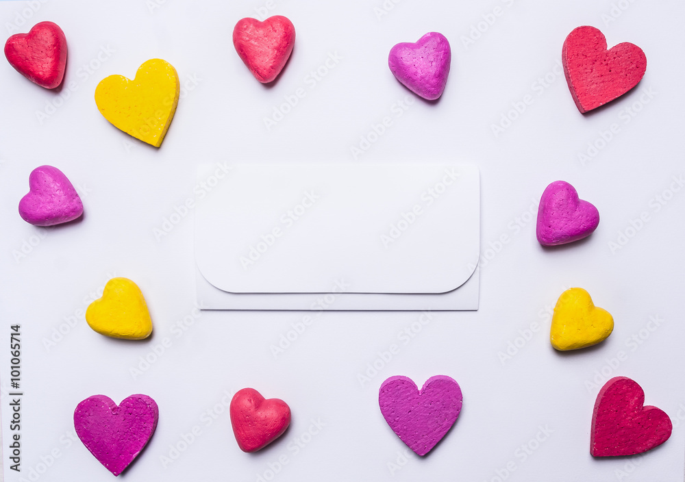 white envelope with red hearts around colorful on white wooden rustic background top view close up decorations for Valentine's Day place for text,frame white envelope with red hearts around colorful on white wooden rustic background top view close up decorations for Valentine's Day place for text,frame