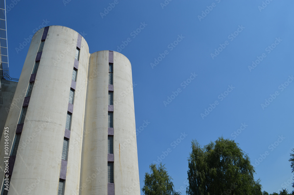 Tall white modern university building with small windows Tall white modern university building with small windows