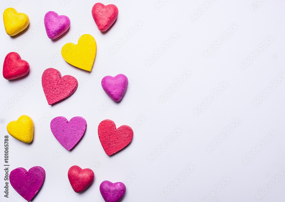colorful background of hearts for Valentine's Day border ,place for text on white wooden rustic background top view close up