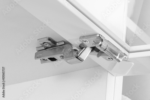 Closeup of furniture cabinet modern clip hinge with amortization
