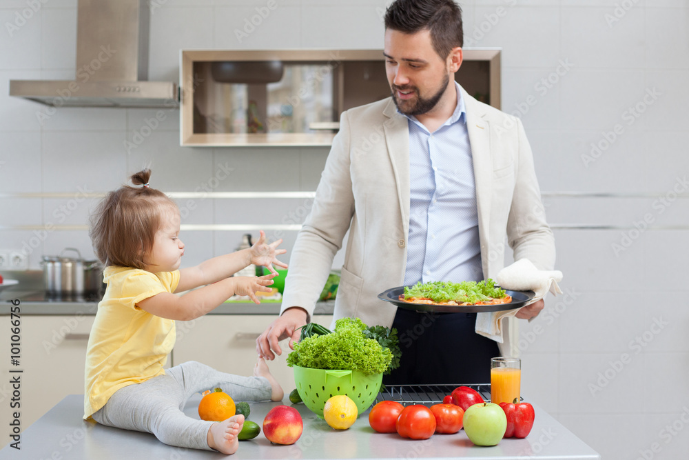Father and child preparing pizza together Father and child preparing pizza together