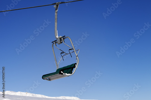 Chair-lift and blue sky photo