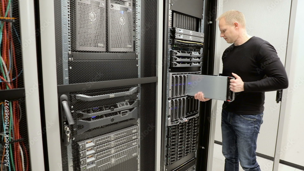 IT consultant removes blade server in datacenter