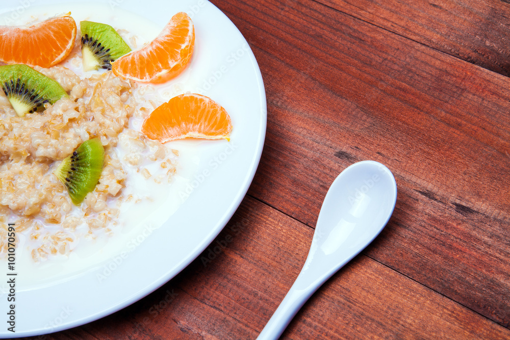oatmeal in a white dish on a wooden background oatmeal in a white dish on a wooden background