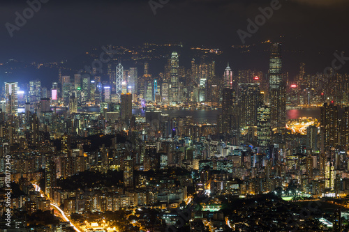 View of Kowloon and Hong Kong Island from above in Hong Kong, China, at night.