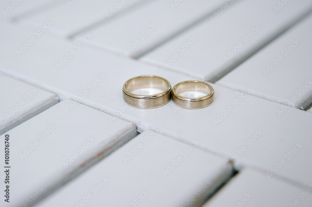 Wedding rings on white wooden background Wedding rings on white wooden background