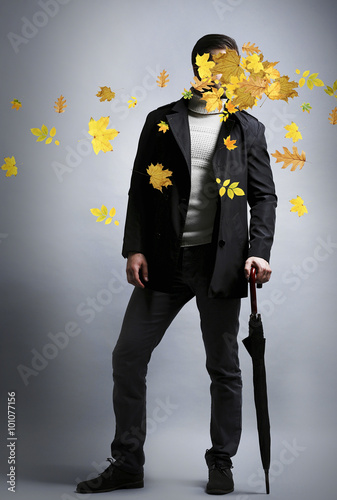 Young man and falling autum...