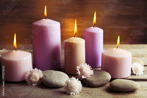 Fototapeta Naklejka Na Ścianę i Meble -  Spa set with candles, pebbles and flowers on wooden background