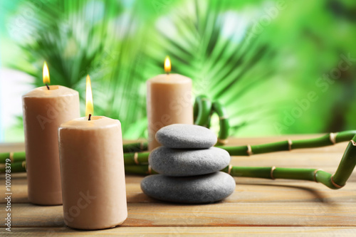 Spa composition of candles  stones and bamboo on blurred background