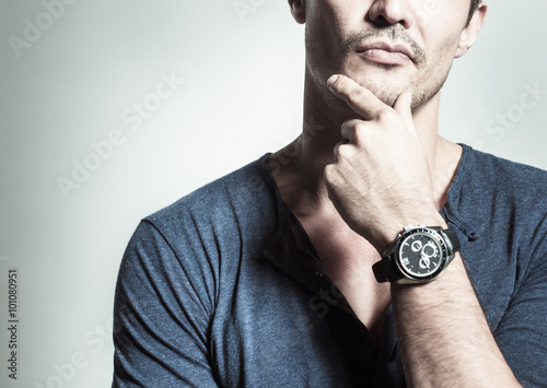 Man with watch thinking.
 photo