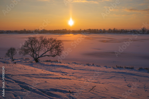 Warm freeze or fozen sun. Landscape at the river's bank photo