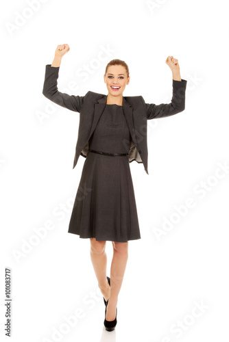Young happy business woman with arms up