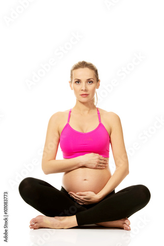 Pregnant woman sitting cross legged 