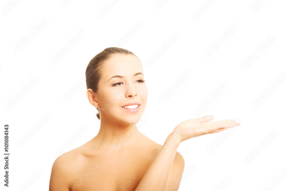 Nude woman with open hand showing space Nude woman with open hand showing space