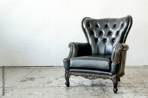 Black genuine leather classical style sofa in vintage room