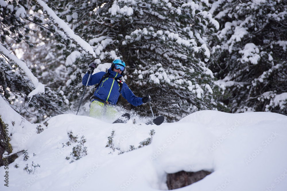 freeride skier skiing in deep powder snow