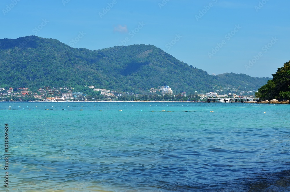 View of the sea, sky and mountains overgrown with jungle Tri Trang Beach in Phuket