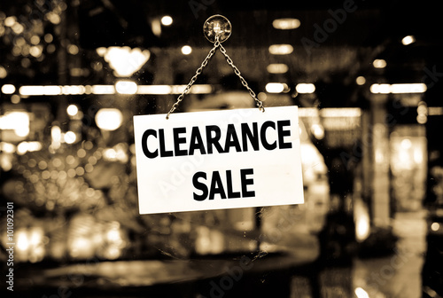 A Clearance sale sign hanging in a shop window