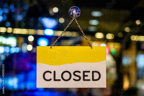A closed sign hanging in a shop window